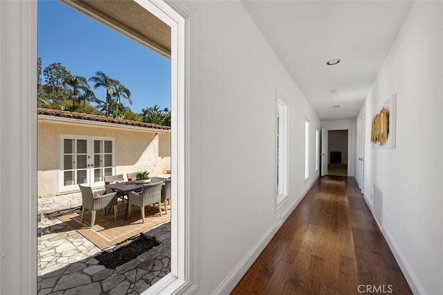 hall with wood finished floors, french doors, baseboards, and visible vents