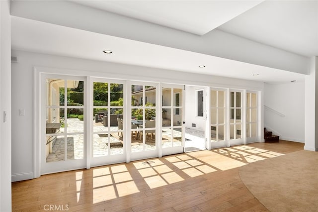 doorway to outside with recessed lighting, stairway, baseboards, and hardwood / wood-style flooring