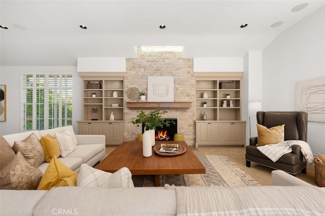 living room with light colored carpet, a fireplace, and built in shelves