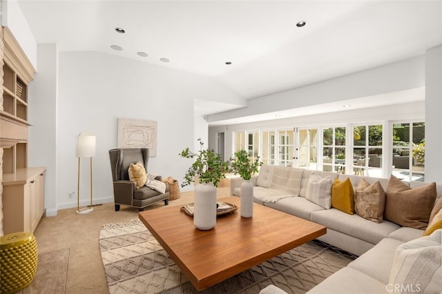 living room featuring vaulted ceiling, recessed lighting, light colored carpet, and french doors