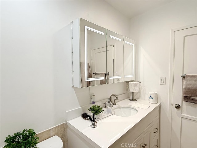 bathroom with toilet and vanity