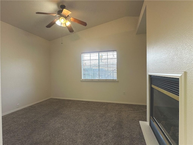 unfurnished living room featuring lofted ceiling, carpet floors, a ceiling fan, and baseboards