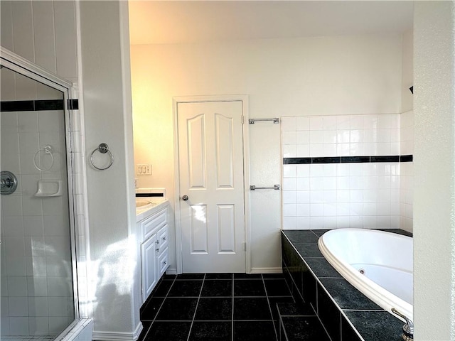 bathroom featuring a garden tub, a shower stall, vanity, and tile patterned floors