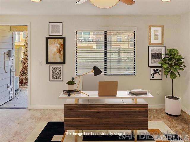 office area featuring baseboards and ceiling fan