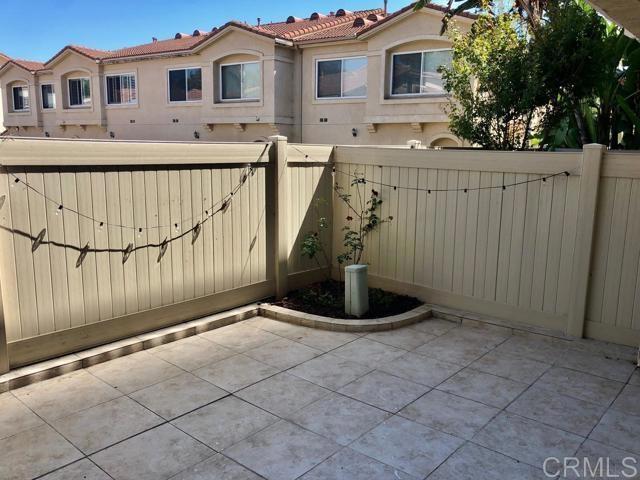 view of gate with a patio and fence