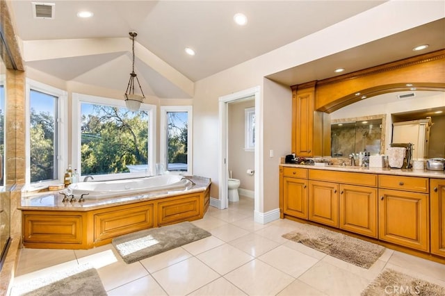 bathroom with a garden tub, visible vents, toilet, vaulted ceiling, and vanity