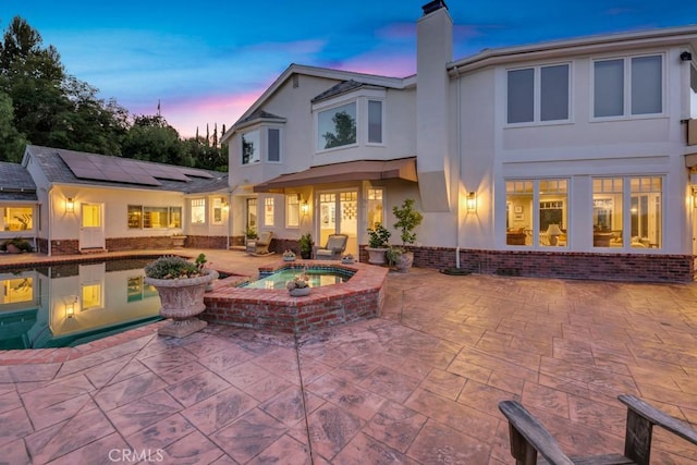 view of patio with an in ground hot tub