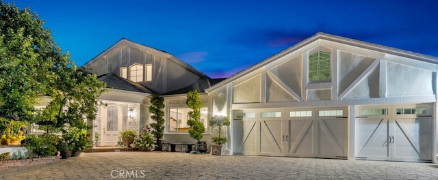 view of front of house featuring an attached garage and decorative driveway