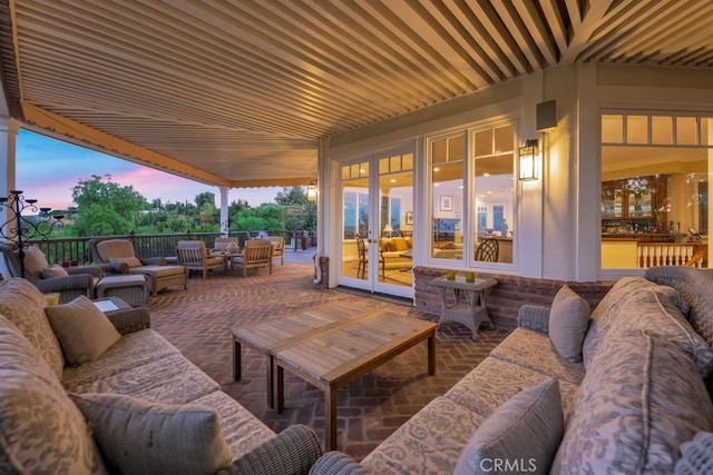 patio terrace at dusk with an outdoor hangout area and french doors