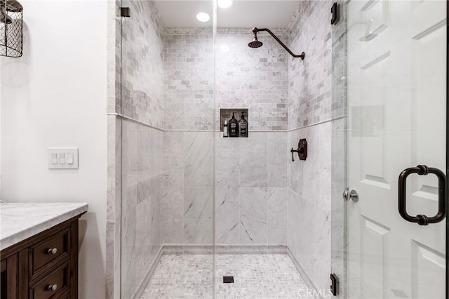 full bathroom with a shower stall and vanity