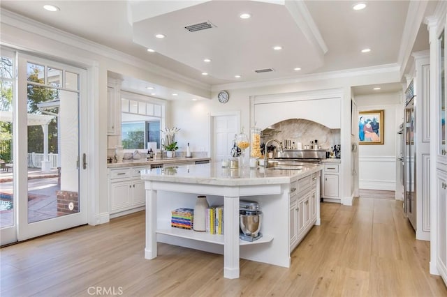 kitchen featuring open shelves, light wood-type flooring, white cabinetry, and crown molding