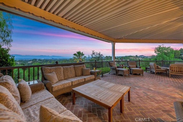 patio terrace at dusk featuring an outdoor hangout area