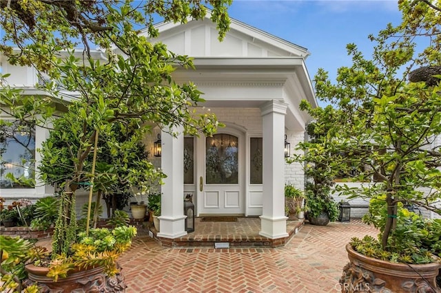 property entrance featuring brick siding