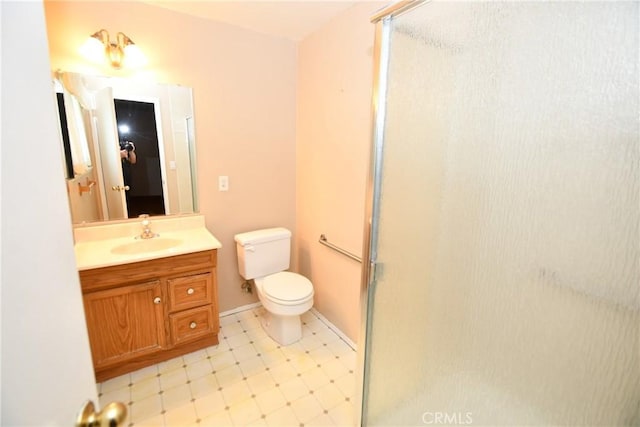 bathroom with toilet, tile patterned floors, a shower stall, and vanity