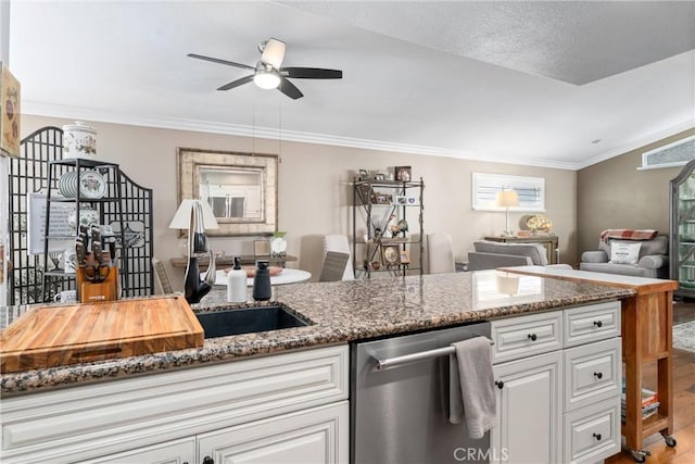 kitchen featuring ornamental molding, open floor plan, white cabinets, dark stone countertops, and dishwasher