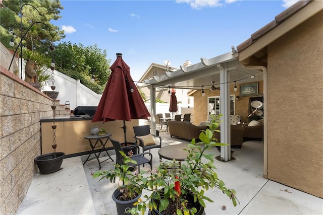 view of patio / terrace featuring outdoor lounge area and fence