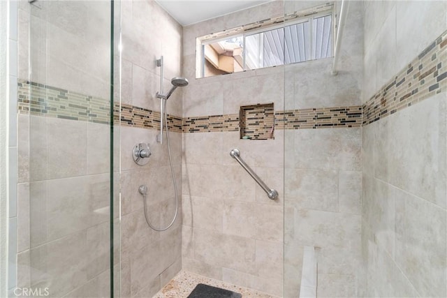 bathroom with a tile shower