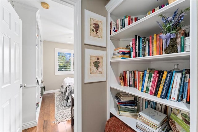 interior space featuring baseboards and wood finished floors