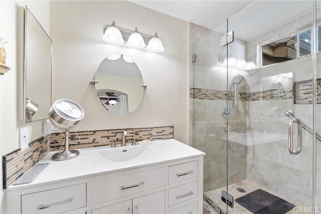 bathroom featuring backsplash, vanity, and a shower stall