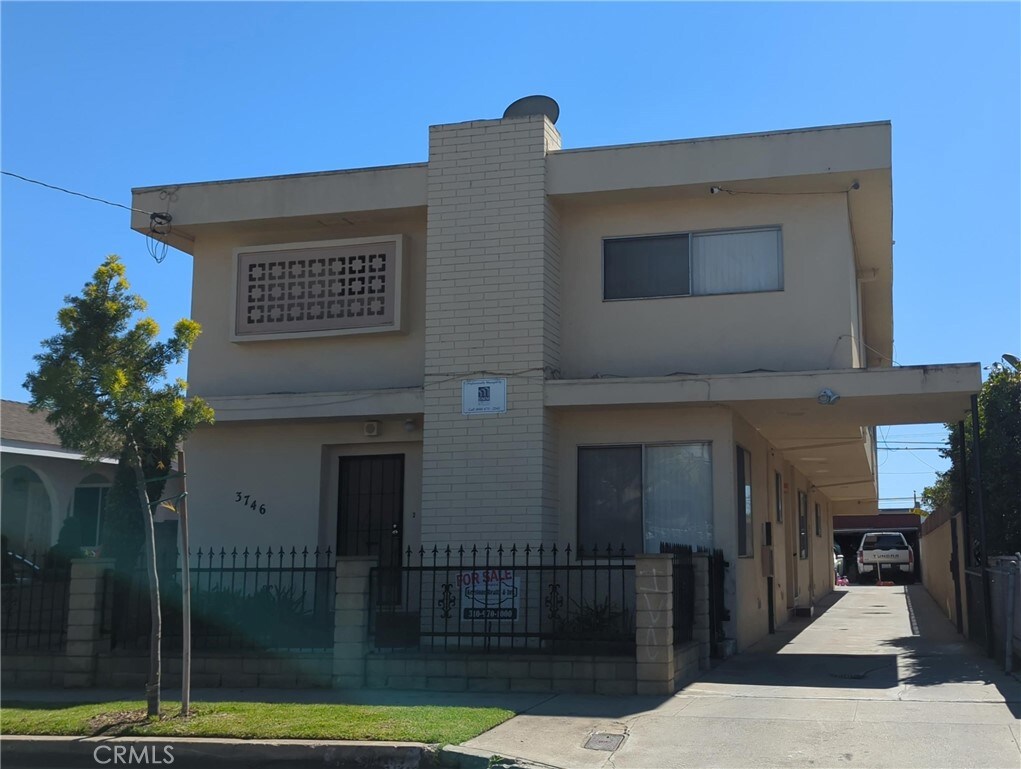 3746 W 113th St Unit 1, Inglewood, CA 90303 - view of front of home featuring concrete driveway, brick siding, fence, and stucco siding