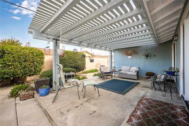 view of patio with outdoor lounge area and fence