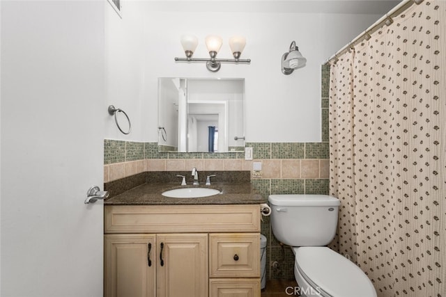 full bath with toilet, tile walls, and vanity