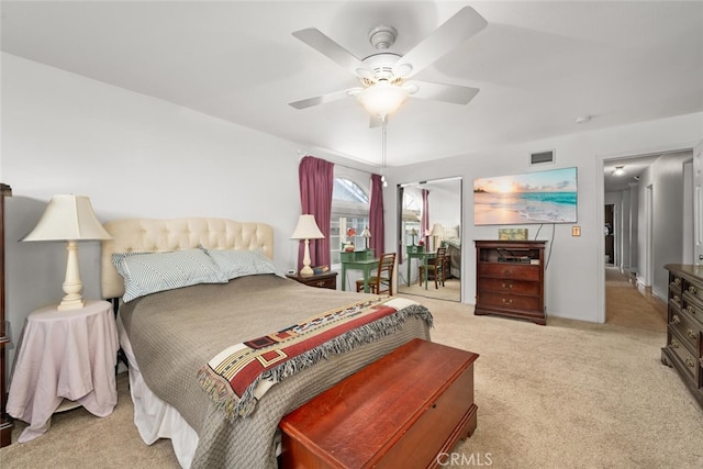 bedroom with carpet, visible vents, and a ceiling fan