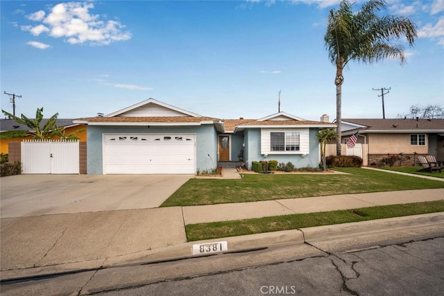 single story home featuring concrete driveway, an attached garage, a gate, fence, and a front lawn