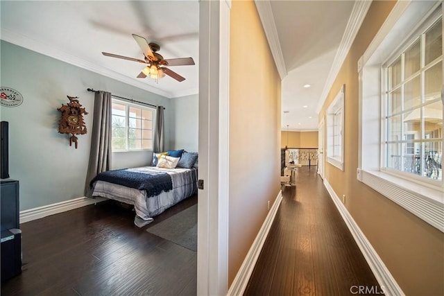 bedroom with baseboards, wood finished floors, and ornamental molding