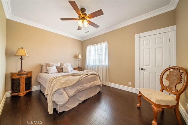 bedroom featuring dark wood-type flooring, baseboards, and ornamental molding