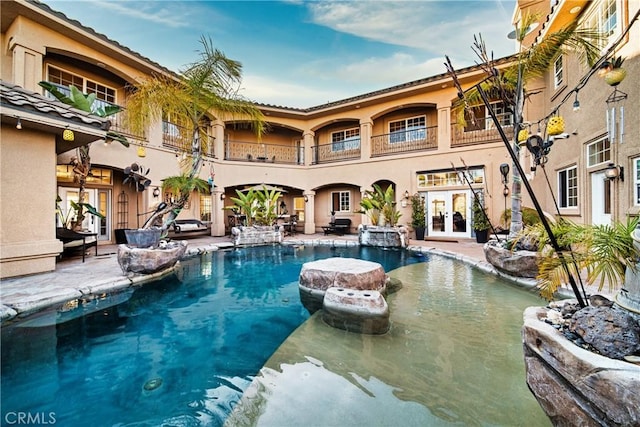 pool featuring a patio and french doors