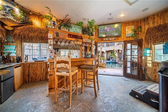 dining room with french doors and wood walls