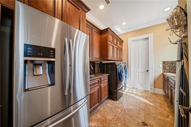 laundry area with recessed lighting, separate washer and dryer, crown molding, baseboards, and laundry area