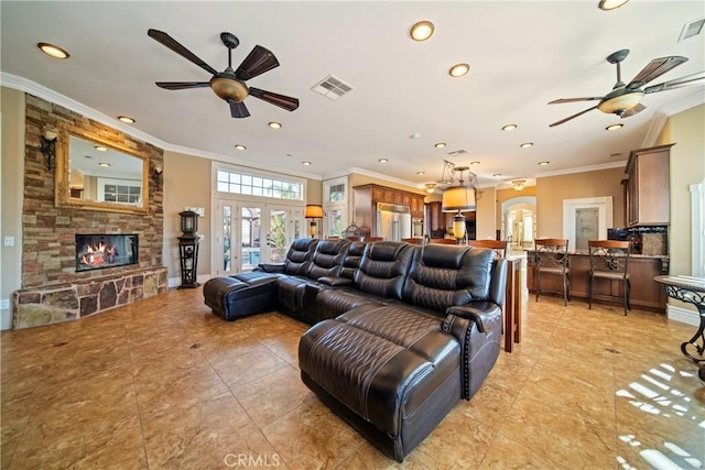 living area with visible vents, french doors, ceiling fan, and ornamental molding