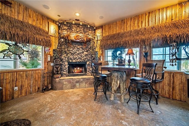 bar featuring wooden walls and a fireplace