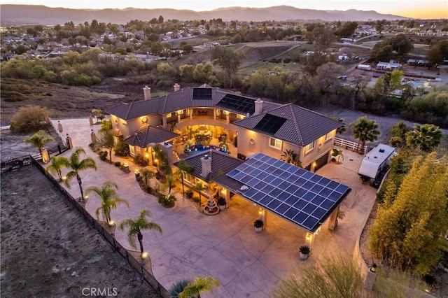 aerial view at dusk featuring a mountain view