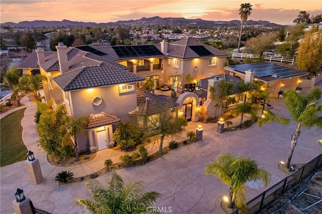 aerial view at dusk featuring a mountain view