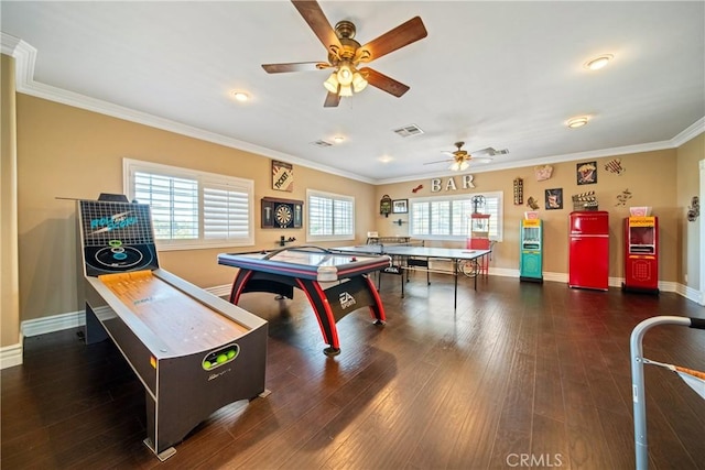 game room featuring hardwood / wood-style floors, visible vents, baseboards, and ornamental molding