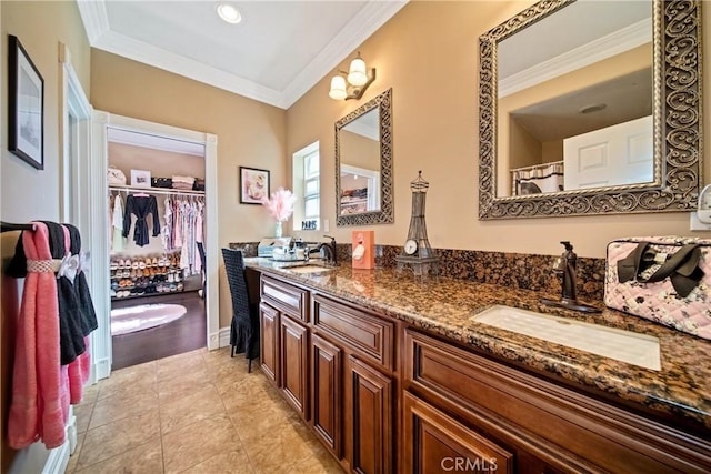 full bathroom with a sink, double vanity, crown molding, and tile patterned floors