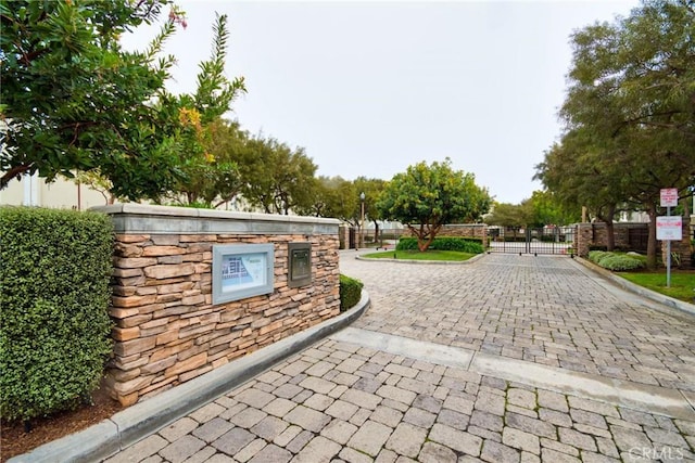 view of property's community with a gate and fence