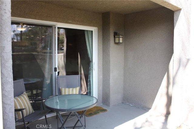 exterior space featuring outdoor dining area and stucco siding