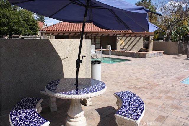 view of pool featuring a patio area, fence, and a swimming pool