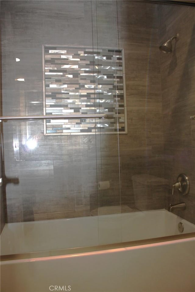 bathroom featuring shower / bath combination with glass door