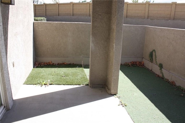 view of patio featuring fence