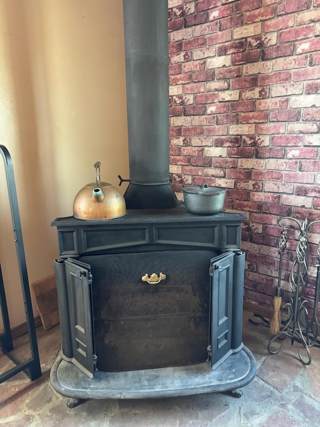 interior details featuring a wood stove and unfinished concrete floors