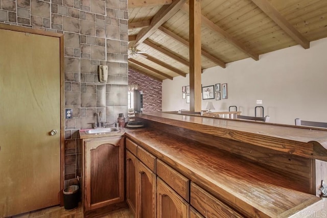 interior space with vanity, lofted ceiling with beams, a ceiling fan, wooden ceiling, and wood finished floors