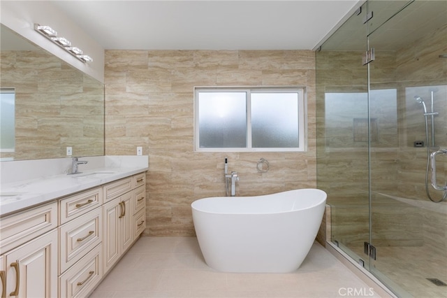 4 Singletree Ln, Rolling Hills Estates, CA 90274 - bathroom featuring a stall shower, tile walls, double vanity, tile patterned floors, and a freestanding tub