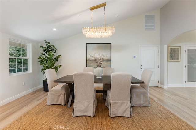 4 Singletree Ln, Rolling Hills Estates, CA 90274 - dining space with arched walkways, light wood finished floors, baseboards, and high vaulted ceiling