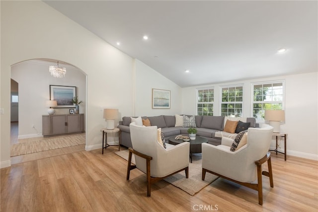 living room with baseboards, recessed lighting, light wood-style floors, arched walkways, and high vaulted ceiling