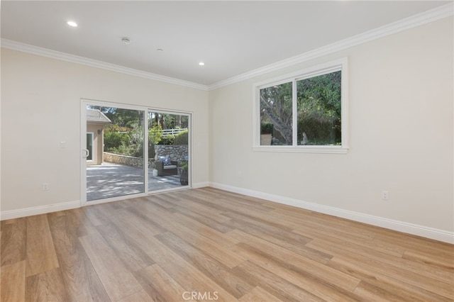 empty room with crown molding, baseboards, and light wood-type flooring